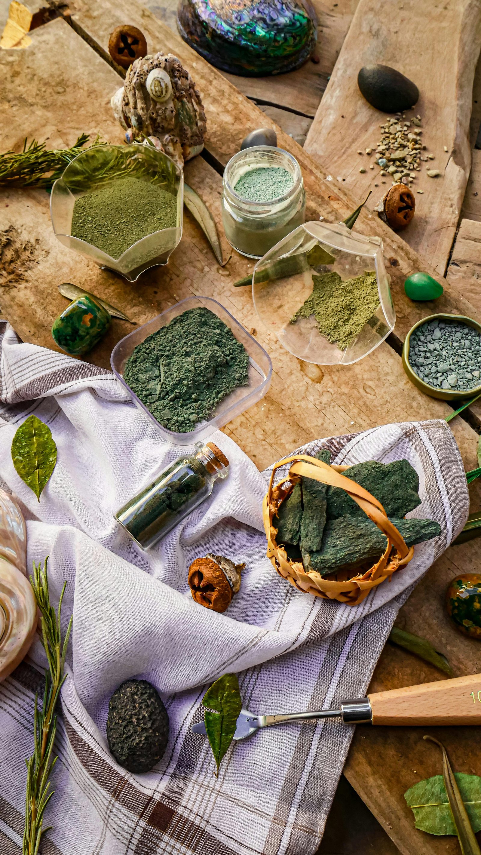 Top view of natural pigments and art materials on a wooden surface in Peru.