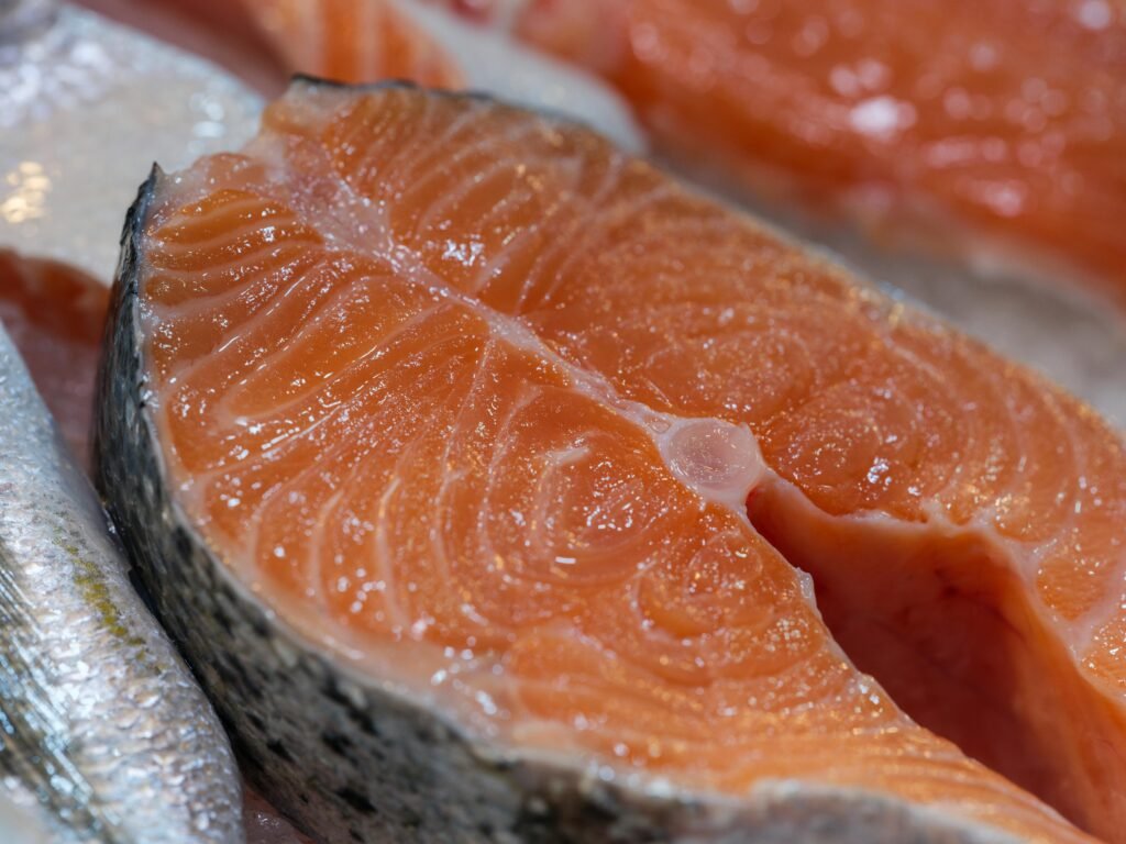 A detailed shot of a fresh salmon slice, showcasing its texture and color, perfect for culinary uses.